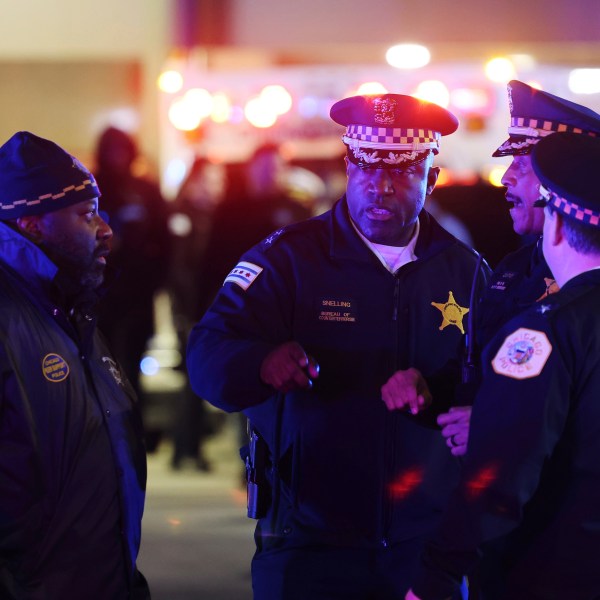 Police supervisors, including Chief of the Bureau of Counterterrorism Larry Snelling, center, prepare to have the body of a Chicago police officer transferred to the Cook County Medical Examiner on March 1, 2023, in Chicago. Chicago Mayor Brandon Johnson on Sunday, Aug. 13, 2023, named Snelling, the police department's counterterrorism head, as his choice for police superintendent of the nation's third-largest city. (John J. Kim/Chicago Sun-Times via AP)