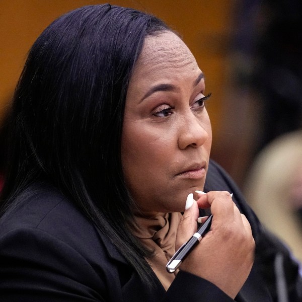 FILE - Fulton County District Attorney Fani Willis watches proceedings during a hearing to decide if the final report by a special grand jury looking into possible interference in the 2020 presidential election can be released Jan. 24, 2023, in Atlanta. Just one month after Donald Trump’s January 2021 phone call to suggest Georgia’s secretary of state could overturn his election loss, Willis announced she was looking into possibly illegal “attempts to influence” the results. (AP Photo/John Bazemore, File)