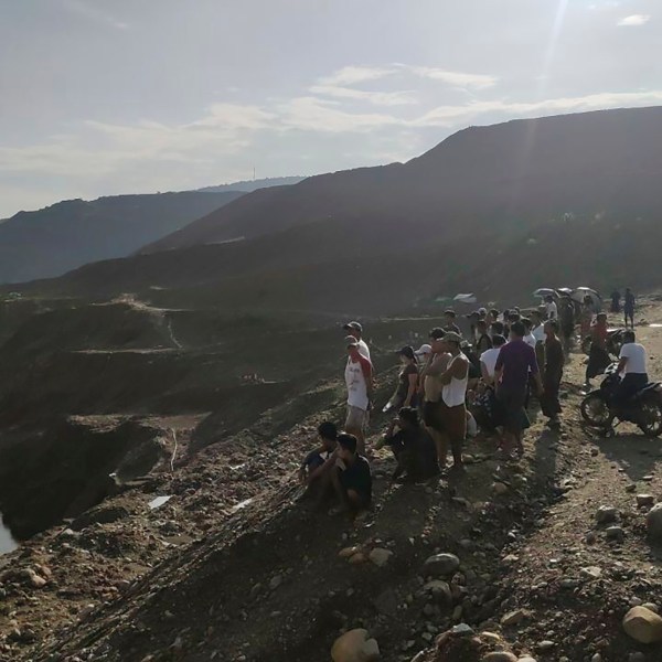 Miners, rescuers and local residents look at the jade mine site where a landslide accident took place in Hpakant township, Kachin state, Myanmar Sunday, Aug. 13, 2023. A landslide at the jade mine left scores of people missing, and a search and rescue operation was underway on Monday, a rescue official said. (AP Photo)